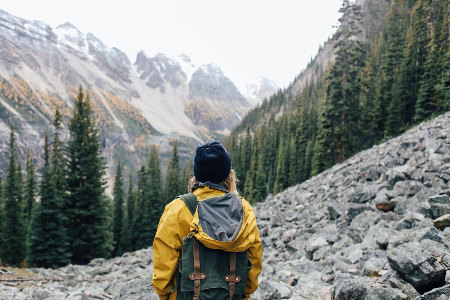 traveler standing on stones in mountainous terrain