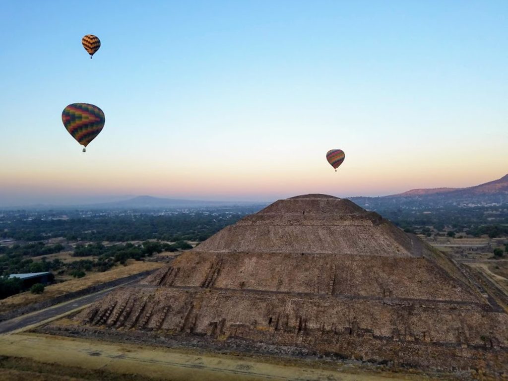 Ancient pyramid of sun under flying air balloons in teotihuacan